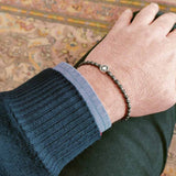 bracciale con sfere e rosa dei venti in acciaio grigio indossato da un uomo - via condotti store