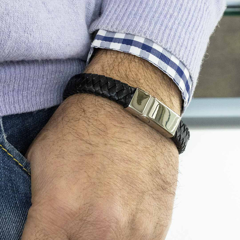 bracciale da uomo in pelle intrecciata nera e acciaio indossato - via condotti store